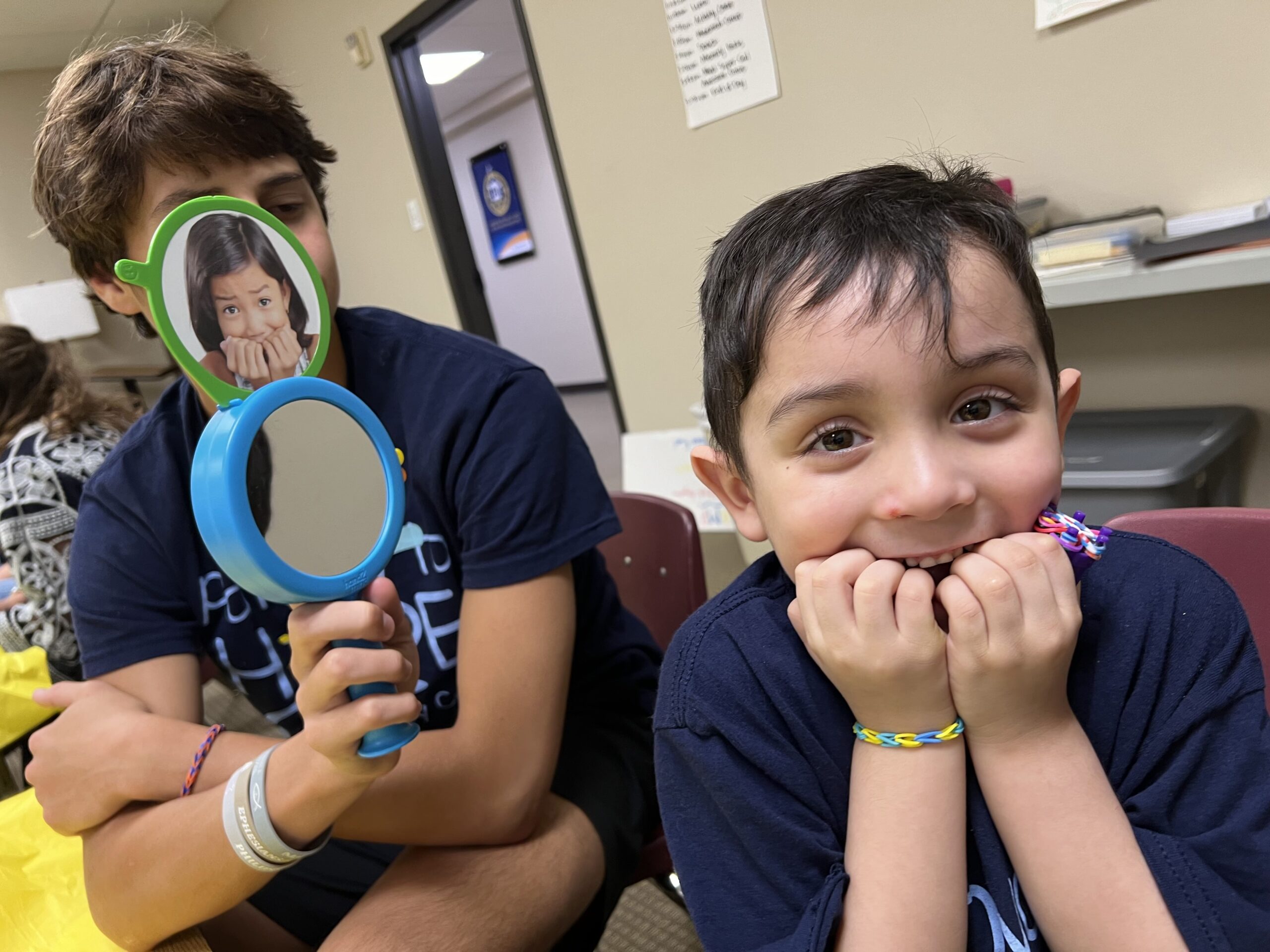 two buys with mirror in hand